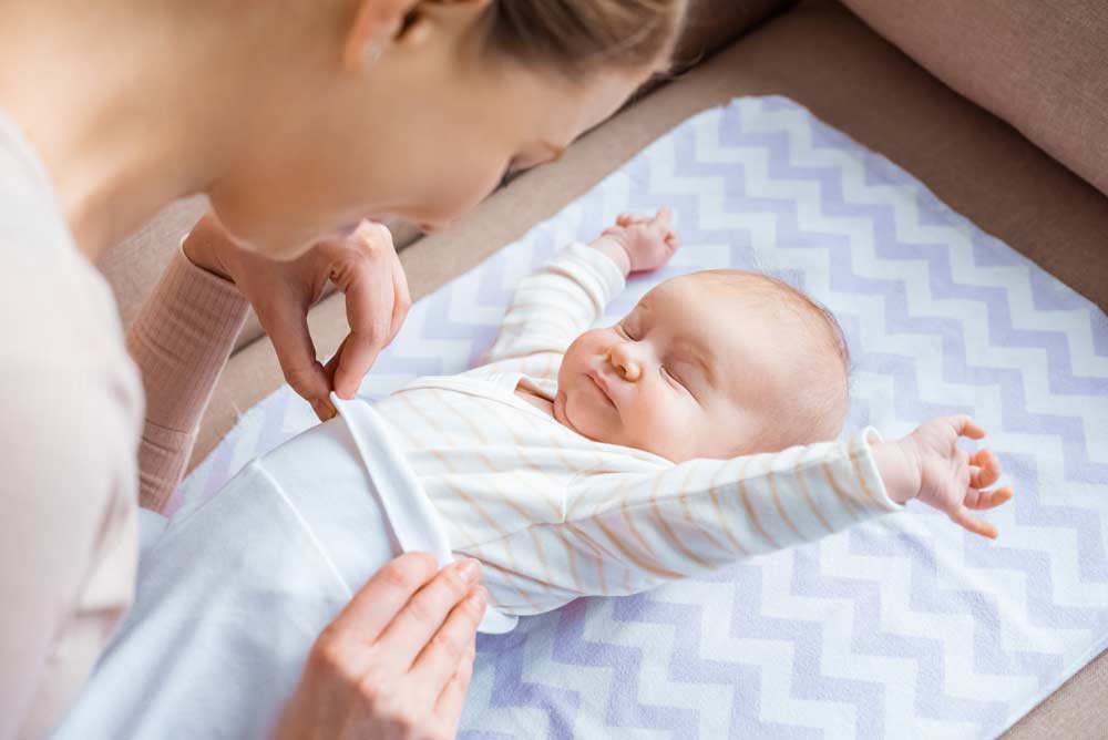 infant stretching while being changed