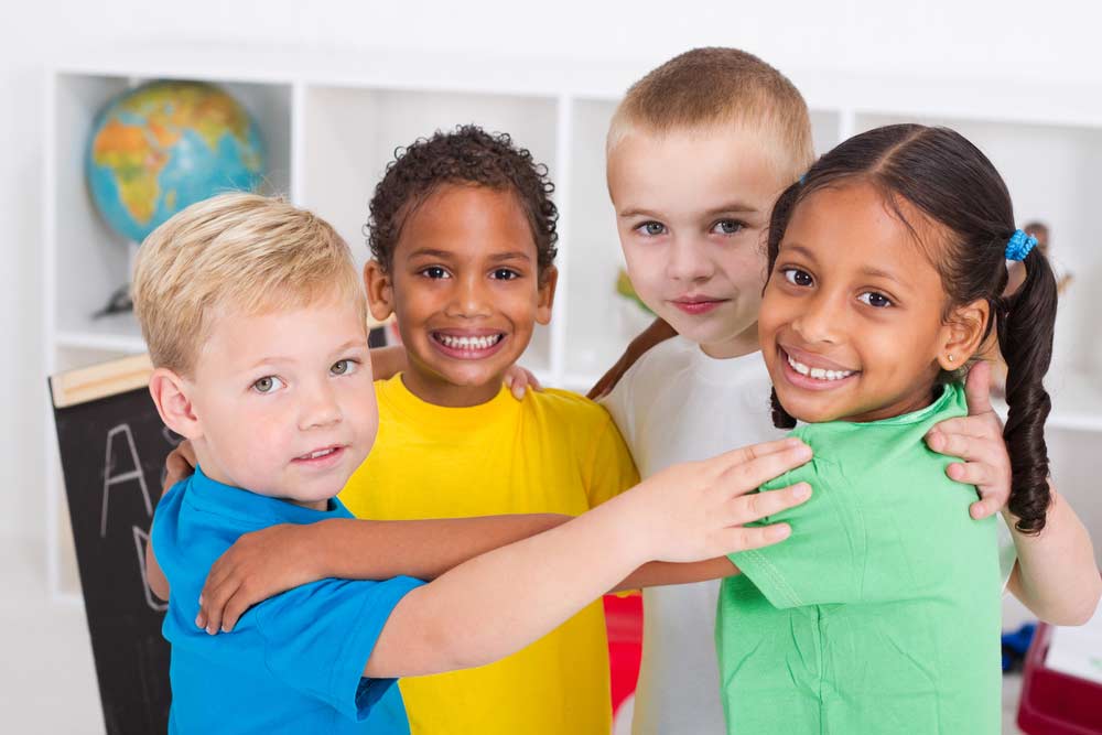 kids group hugging and smiling