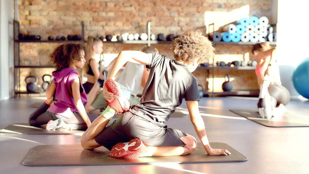 children doing yoga with instructor